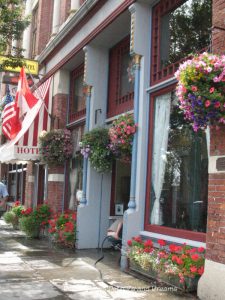 Brick exterior of Palace Hotel in Port Townsend decorated with hanging baskets of flowers