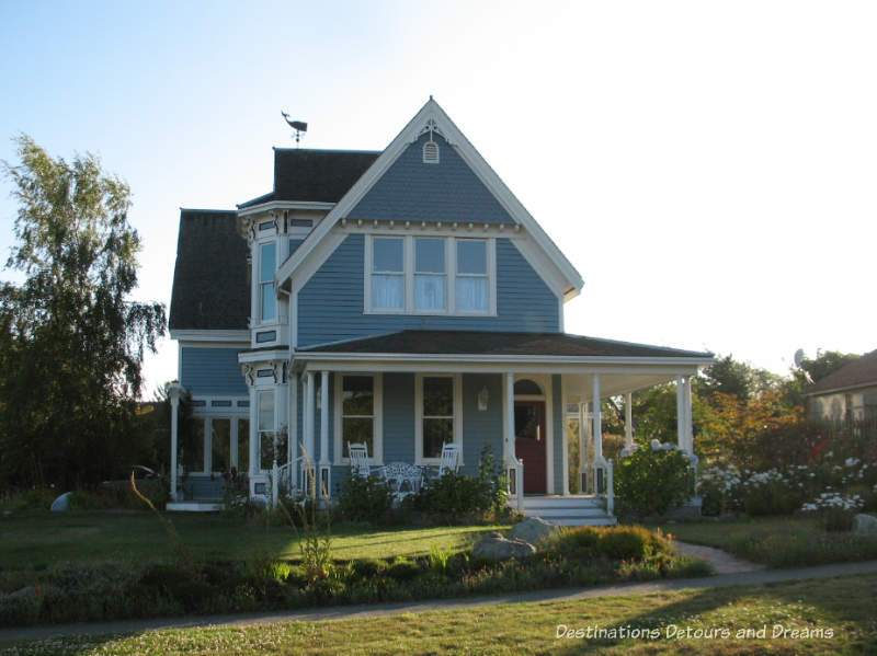 Blue two-story Victorian house with large veranda in Port Townsend, Washington