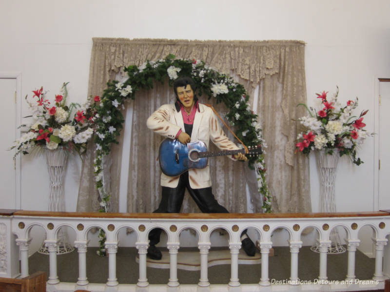 Life=size figure of Elvis playing guitar inside the Elvis Chapel at Superstition Museum