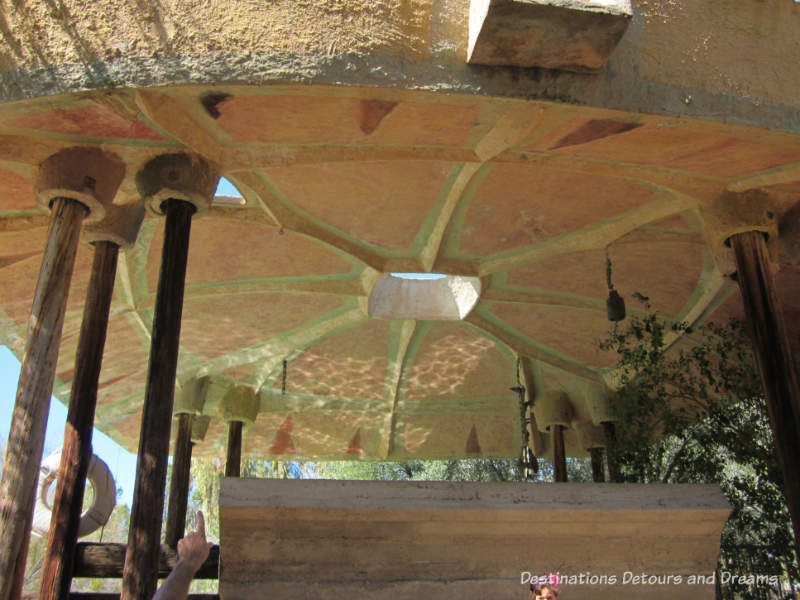 Wood pillars supporting the concrete canopy shading the pool at Cosanti, Paradise Valley, Arizona