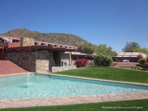 Pool and yard in front of Taliesin West house with mountain in background