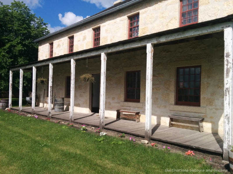 Wooden verandah at front of two-story limestone house