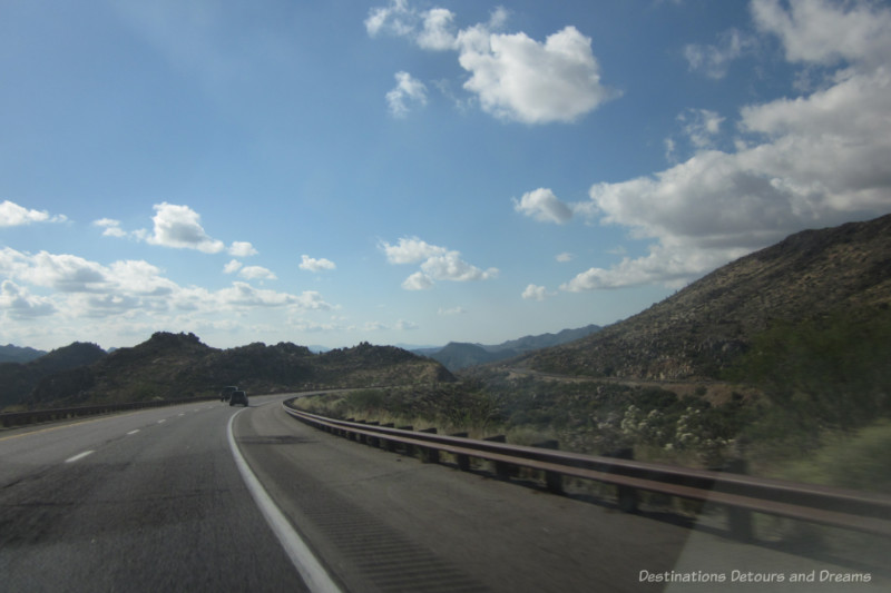 A highway curving through low mountains