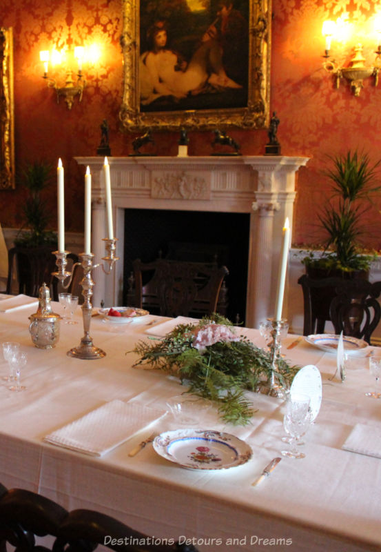 Elegant formal dining table with white fireplace in background