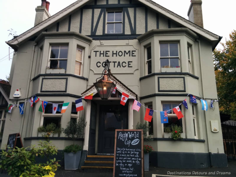 Two story pub and inn with bay windows and decorated with flags in Redhill, Surrey