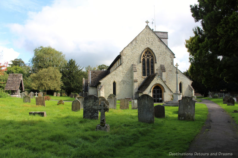 Old stone church surrounded by weathered tombstones - in Betchworth
