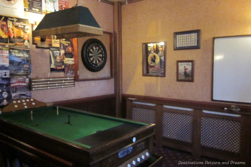 Pool table and dart board in English pub