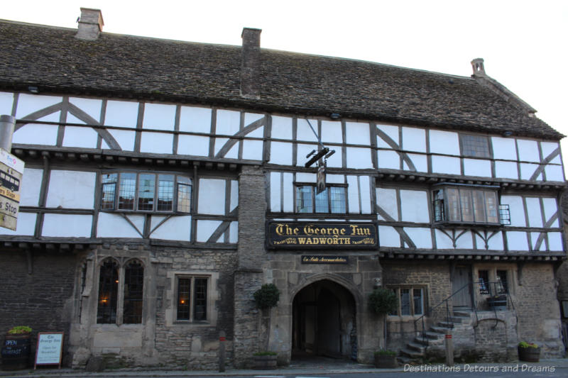 14th century English inn with stone base and timbered upper half