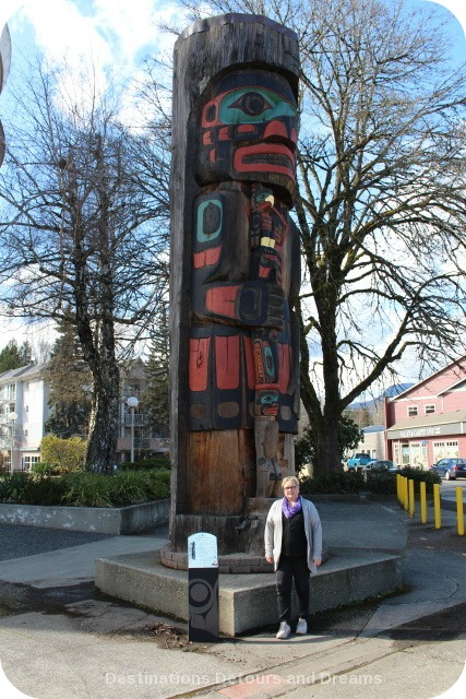 Cedar Man Walking out of the Log by Gwe-la-y-gwe-la-gya-les (Richard Hunt) totem pole in Duncan British Columbia (the City of Totems)