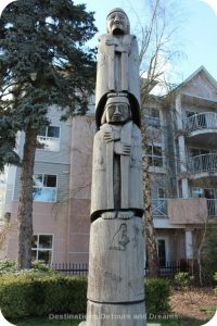 Cedar Woman and Man by Hwunu'metse' (Simon Charlie) totem pole in Duncan, British Columbia (the City of Totems)