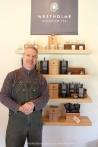 Victor Vesely in front of a shelf of Westholme Canadian teas