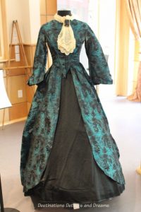 Woman’s turquoise silk brocade opera gown from 1850. Dressing Up: Celebrating Canada's New Years Through The Decades. Highlights from the Eve of Elegance Exhibit by the Costume Museum of Canada.