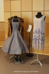 A 1926 mauve/grey beaded georgette French gown alongside a mauve/grey silk taffeta cocktail dress and mink stole from the 1950s. Dressing Up: Celebrating Canada's New Years Through The Decades. Highlights from the Eve of Elegance Exhibit by the Costume Museum of Canada.