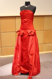 Arnold Scassi red satin strapless gown from the 1980s. Dressing Up: Celebrating Canada's New Years Through The Decades. Highlights from the Eve of Elegance Exhibit by the Costume Museum of Canada.