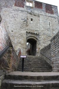 Farnham Castle gatehouse. History and British Charm in Farnham. Farnham is a historic British market town located on the western edges of Surrey in the rolling Surrey Hills. It is known for its Georgian streets, historic buildings, craft heritage, and easy access to the North Downs Way.