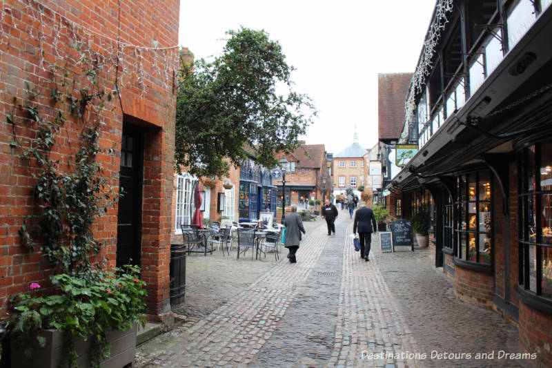 History and British Charm in Farnham. Farnham is a historic British market town located on the western edges of Surrey in the rolling Surrey Hills. It is known for its Georgian streets, historic buildings, craft heritage, and easy access to the North Downs Way. Lamb and Lion Yard