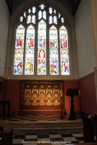 East window of St. Andrew's Church in Farnham. History and British Charm in Farnham. Farnham is a historic British market town located on the western edges of Surrey in the rolling Surrey Hills. It is known for its Georgian streets, historic buildings, craft heritage, and easy access to the North Downs Way.