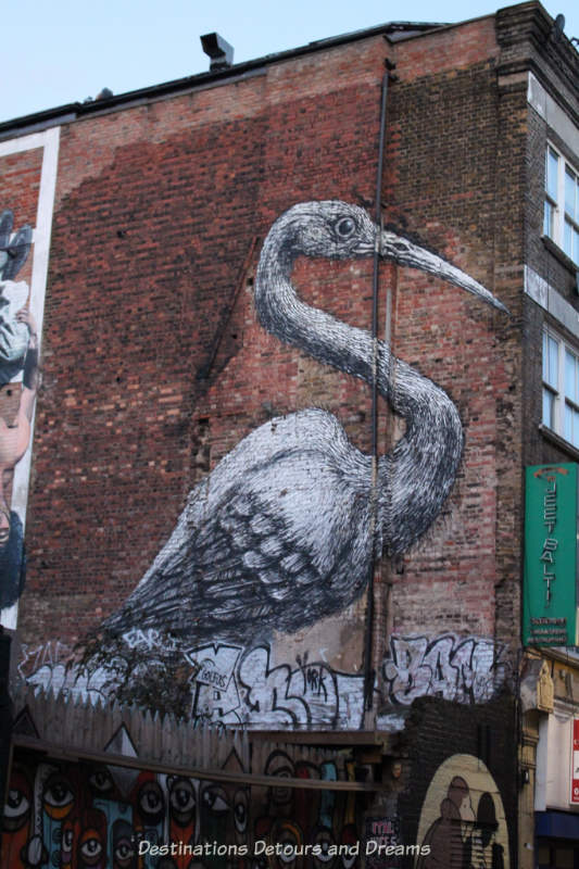 London street art in Brick Lane: crane by ROA