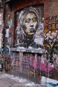 London street art in Shoreditch: lady's face and dripping paint