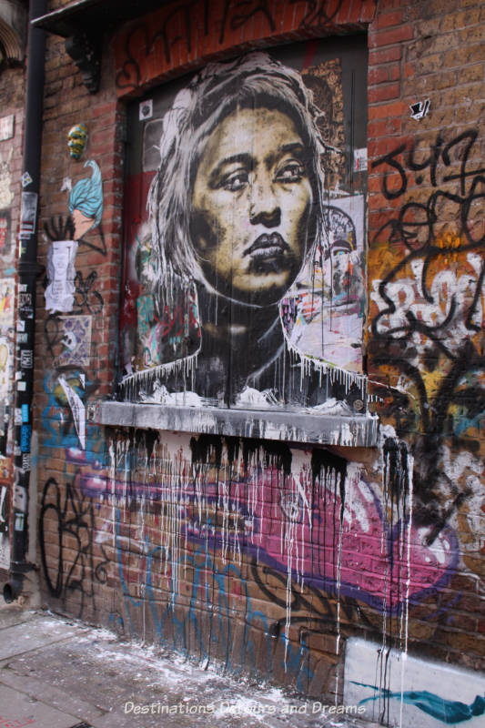London street art in Shoreditch: lady's face and dripping paint