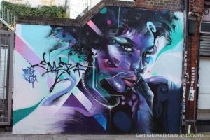 London street art in Brick Lane: purple face of a lady painted by Mr Cenz