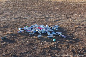 Paint cans litter field at Cadillac Ranch