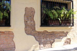 The Colourful Architecture and History of Gringo Gulch, Puerto Vallarta, Mexico: Part of old stone wall left unplastered to reveal brick behind