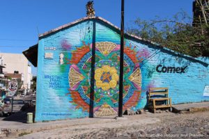 A Restore Coral Mural Project mural by Honhikuri in Puerto Vallarta features circular designs in turquoise, yellow and red