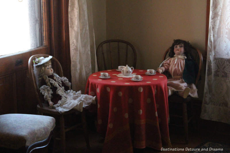 Rossoon House: dolls at tea party in girls' bedroom