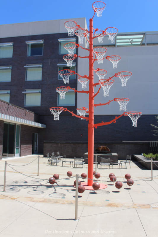 A pole with many basket hoops is an art installation outside 21c Museum Hotel in Bentonville, Arkansas