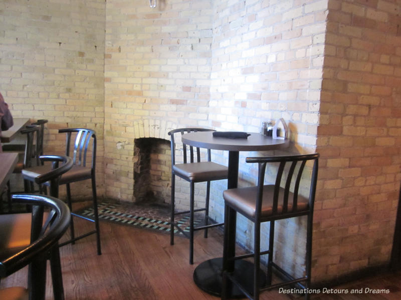 Original fireplace in a corner of the Saddlery on Market restaurant in Winnipeg's Exchange District