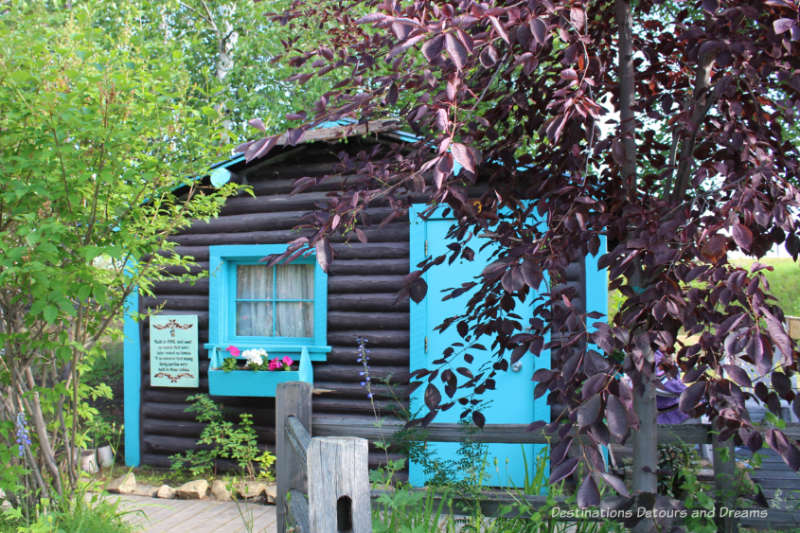 Turquoise trimmed log cabin, once a motel unit, in Pioneer Park in Fairbanks, Alaska
