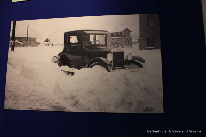 Vintage photo of car stuck in snow at Fountainhead Antique Auto Museum