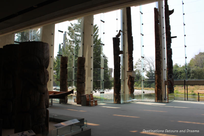 Museum of Anthropology Great Hall and tall windows with view of mountains and forest beyond