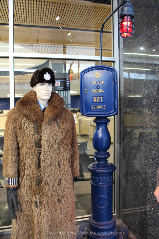 Call box and police officer in an iconic buffalo coat at the Winnipeg Police Museum