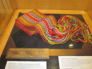 Louis Riel cribbage board and ceinture fléchée (a sash worn by voyaguers) at St. Boniface Museum. Winnipeg, Manitoba