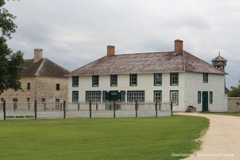 A rebuilt wood building and an original stone building at Lower Fort Garry