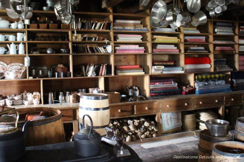 Shelves of clothes, housewares and books and hanging pots in the store at Lower Fort Garry National Historic Site