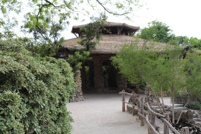 Stone pavilion with thatched roof in San Antonio Japanese Tea Garden