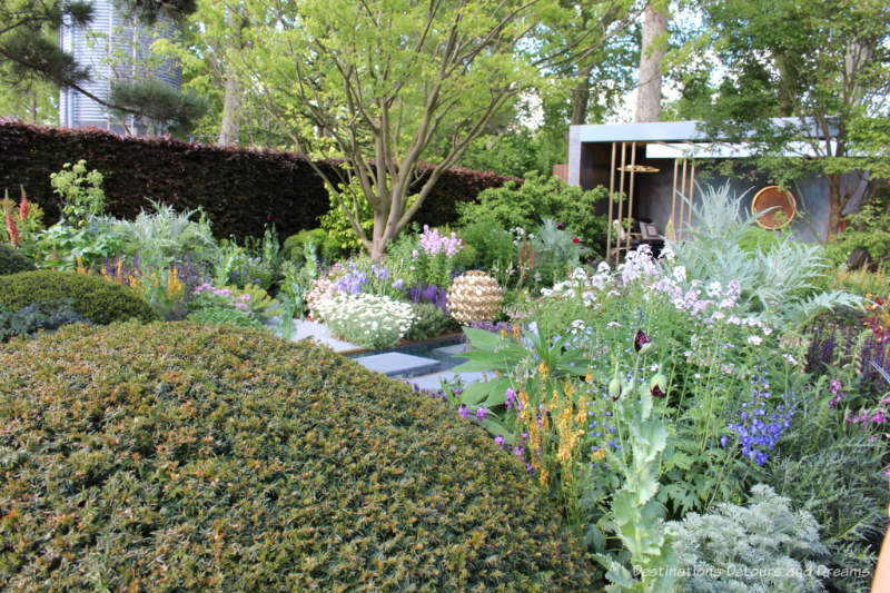 Topiary domes, colourful plants, and a relaxation space in the Morgan Stanley Garden at the 2019 Chelsea Flower Show