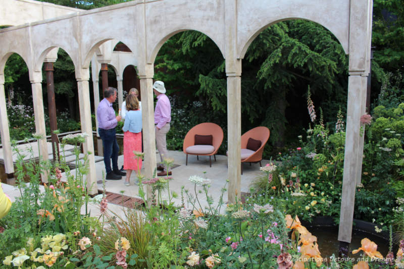 Shade-tolerant naturalistic planting around an architectural structure in the Wedgwood Garden at the 2019 Chelsea Flower Show