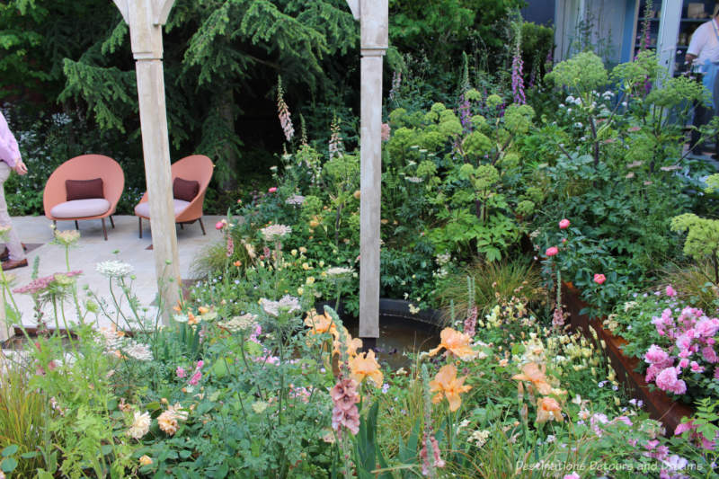 Pond, greenery and architectural structure in the Wedgwood Garden at the 2019 Chelsea Flower Show