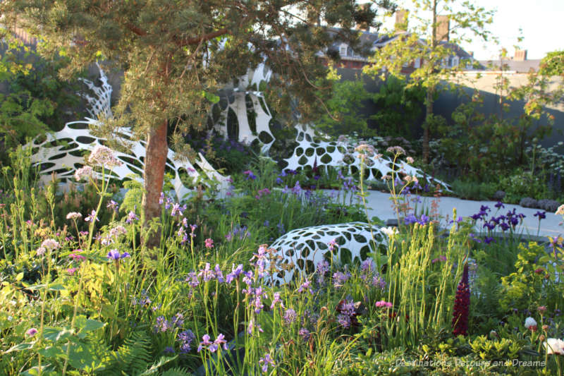 Plants flowing around an undulating white sculpture in the Manchester Garden at the 2019 Chelsea Flower Show