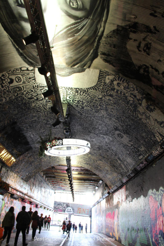 Detailed graffiti art on the ceiling on London Leake Street Tunnel