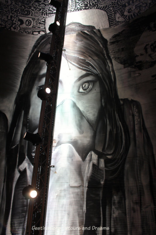 London Graffiti Tunnel: Girl on Ceiling: class= Graffiti girl painted on ceiling of London Leake Street Tunnel