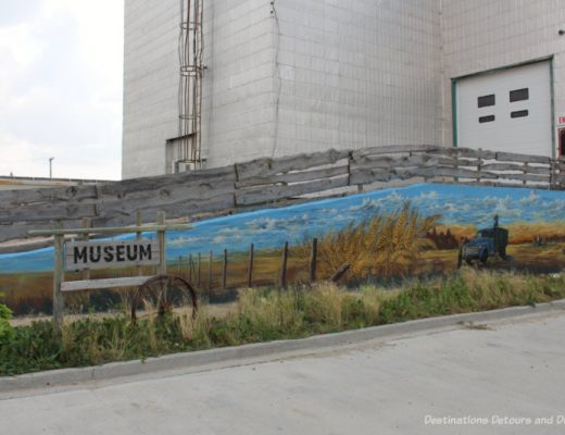 A grain elevator with a mural painted on it houses a museum in Plum Coulee, Manitoba