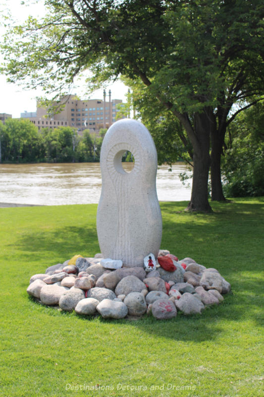 White stone statue surrounded by rocks