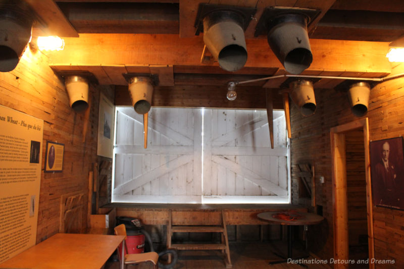 Door leading to railyard and various chutes inside an elevator at the Inglis Grain Elevators Historic Site