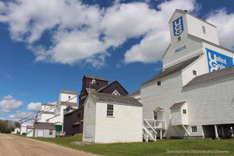 Row of wood grain elevators at Inglis, Manitoba with the UGG elevator in the foreground