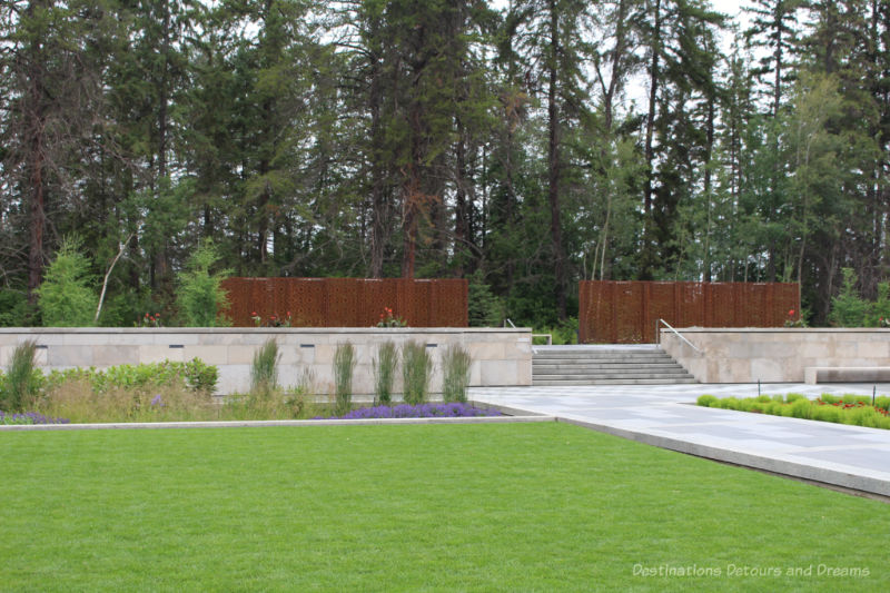 Metal fencing panels and steps leading into the Aga Khan Garden at the Jilau Khana threshold